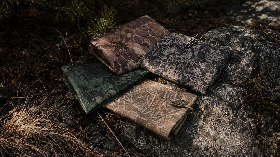 Camouflage fabrics compared against forest rock and grass without people