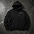 FIELD OATH Boreal Watch Hoodie black hoodie front artwork on dark concrete