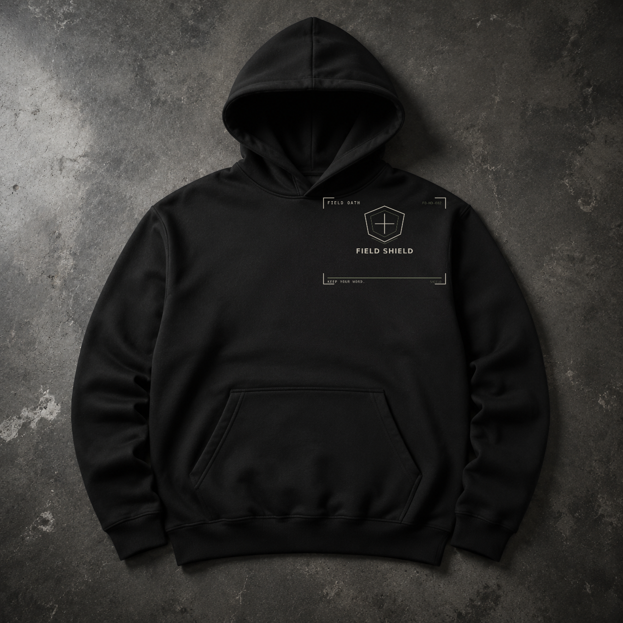 FIELD OATH Field Shield Hoodie black hoodie front artwork on dark concrete