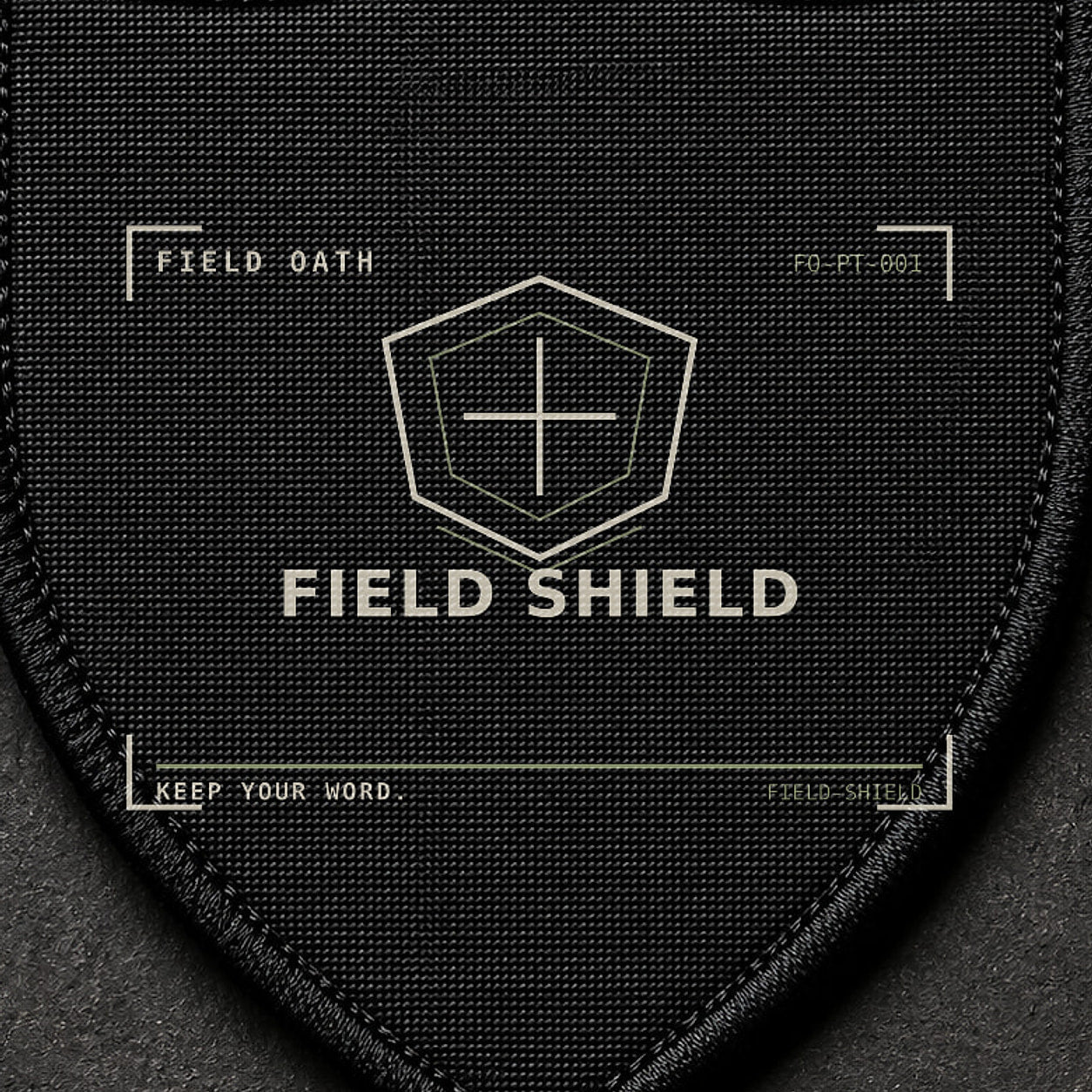 FIELD OATH Field Shield Patch close-up showing woven face, stitched border and embroidery detail
