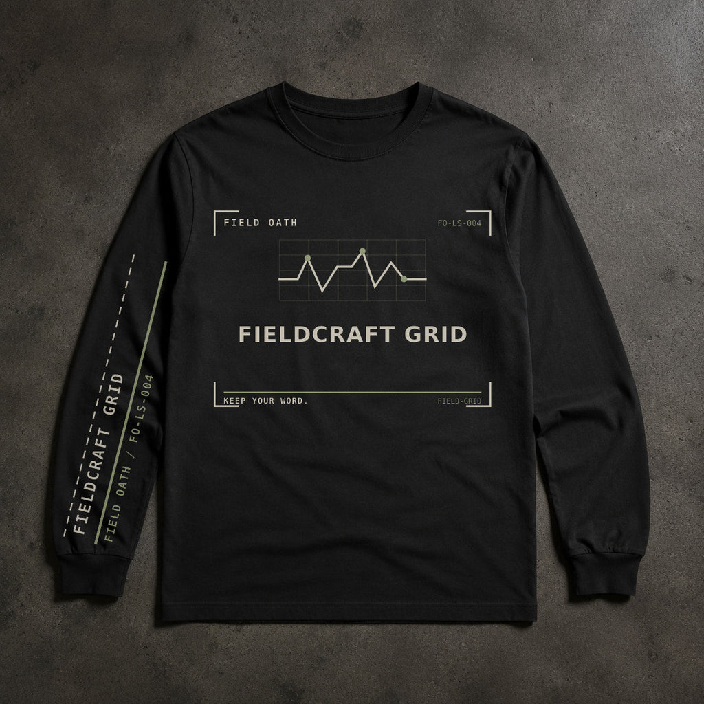 FIELD OATH Fieldcraft Grid Long Sleeve black long sleeve front artwork on dark concrete