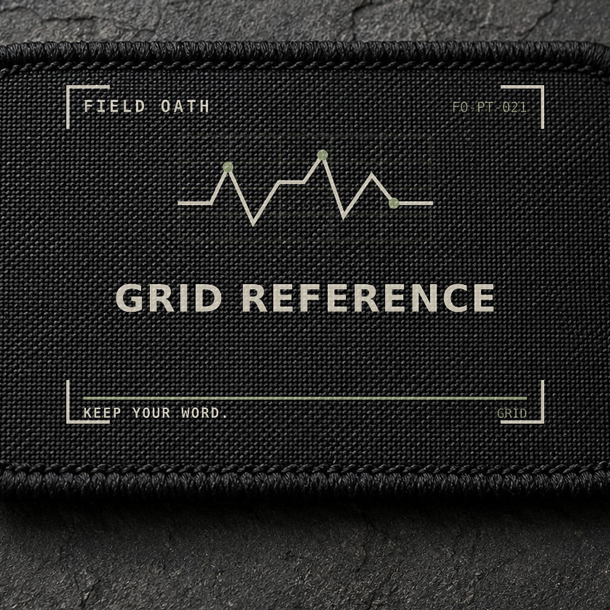 FIELD OATH Grid Reference Patch close-up showing woven face, stitched border and embroidery detail
