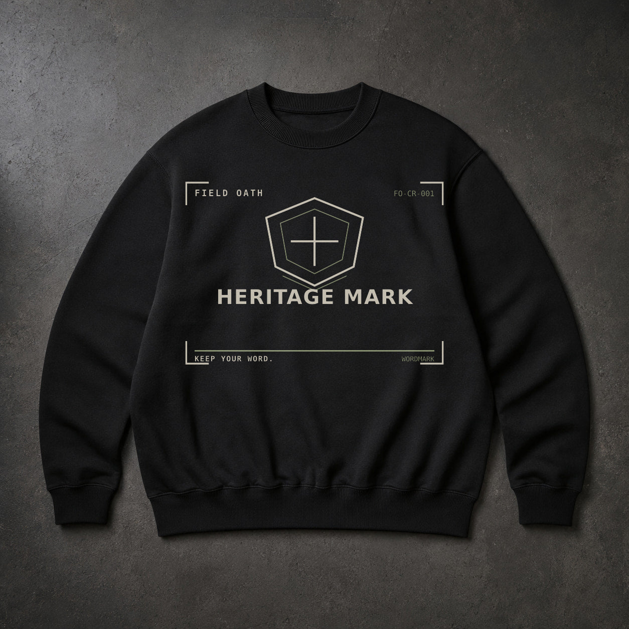 FIELD OATH Heritage Mark Crewneck black crewneck front artwork on dark concrete