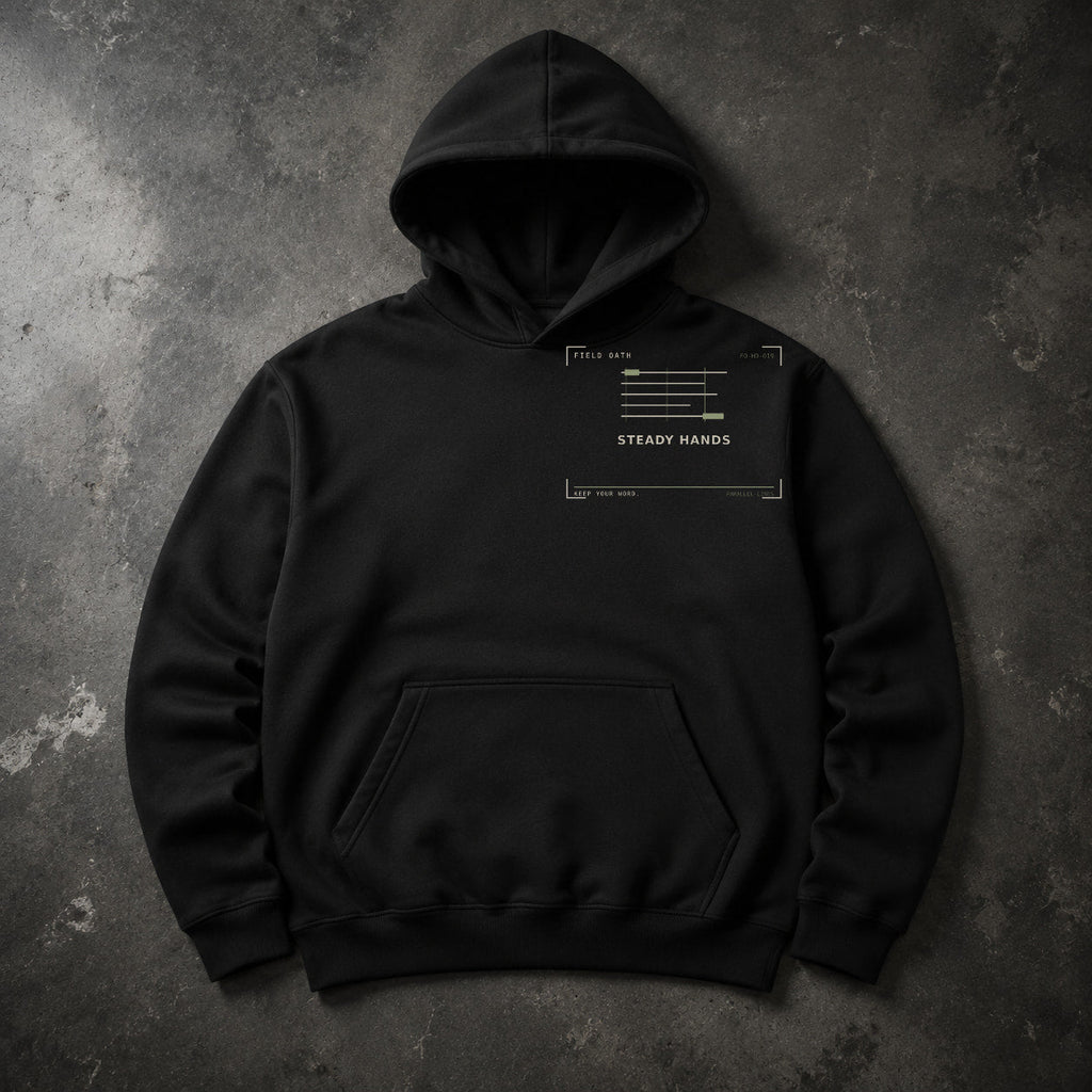 FIELD OATH Steady Hands Hoodie black hoodie front artwork on dark concrete