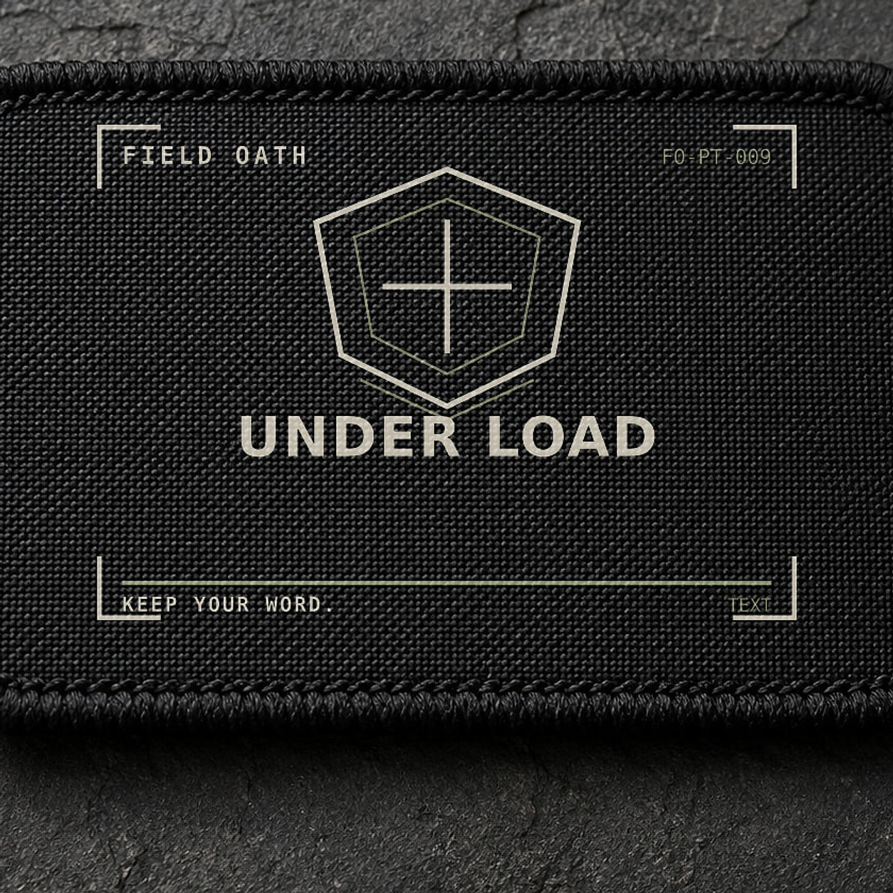 FIELD OATH Under Load Patch close-up showing woven face, stitched border and embroidery detail