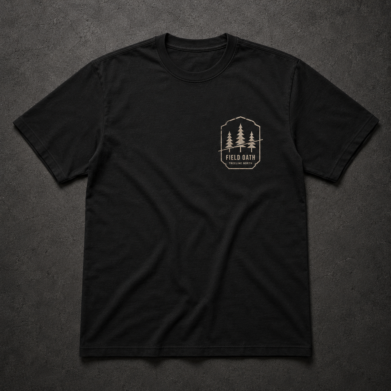 Black FIELD OATH Treeline North T-Shirt front flat lay with pine bearing left-chest artwork