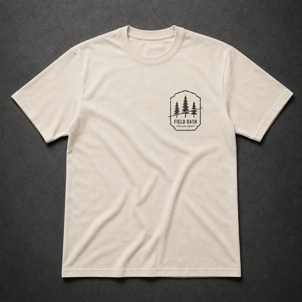 Bone FIELD OATH Treeline North T-Shirt front flat lay with matching pine bearing left-chest artwork